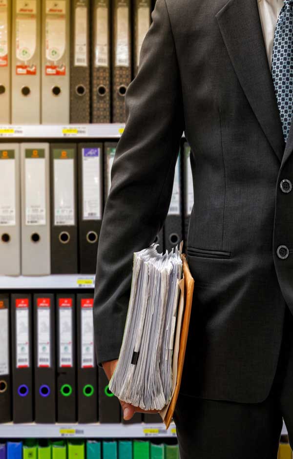 Accountant with files from the bookkeeping archive room