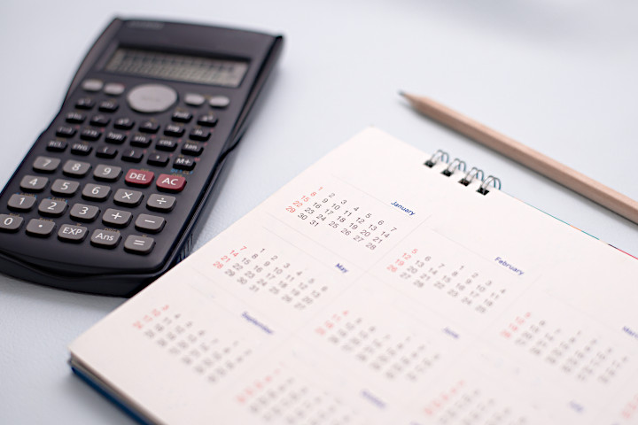 Tax diary, calculator and pencil.